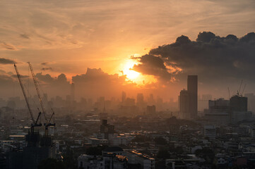 Fototapeta premium Sunrise over Bangkok city with crowded building in downtown
