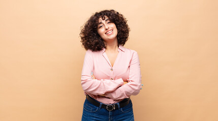  looking like a happy, proud and satisfied achiever smiling with arms crossed