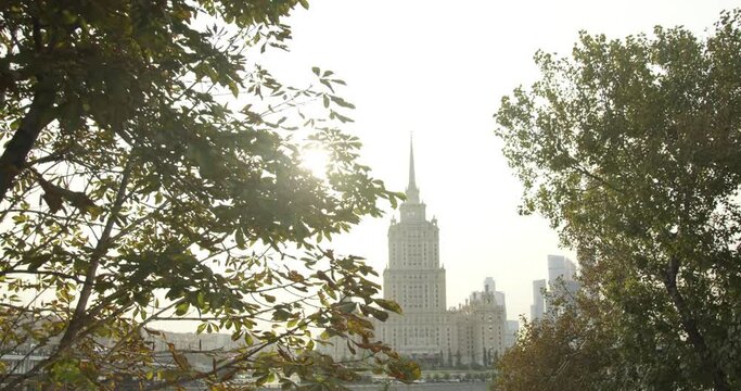 Russia. Moscow. Hotel Radisson "Ukraine" through the leaves on a Sunny day