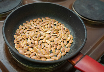 Pumpkin seeds roasted salted in frying pan