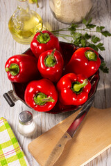 Fresh ripe red bell peppers on the kitchen table