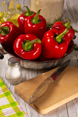 Fresh ripe red bell peppers on the kitchen table