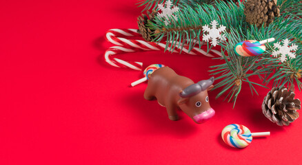 Christmas composition. Fir branches, christmas toys and lights on a red background. New year web banner. Flat lay, top view, copy space