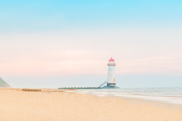 The Point of Ayr Lighthouse, also known as the Talacre Lighthouse, situated on the north coast of Wales, on the Point of Ayr, near the village of Talacre, unreal sunset with pastel colors