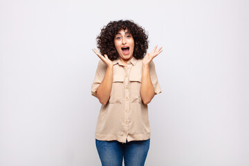  feeling happy, excited, surprised or shocked, smiling and astonished at something unbelievable