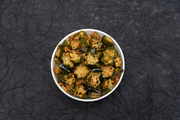 ladies finger Okra fry / Bhindi Masala. Popular Indian side dish with okra tomatoes served with Indian Paratha or rice on side