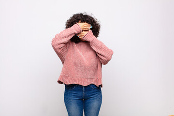  covering face with both hands saying no to the camera! refusing pictures or forbidding photos