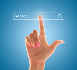 Index finger of a female hand points to the search field