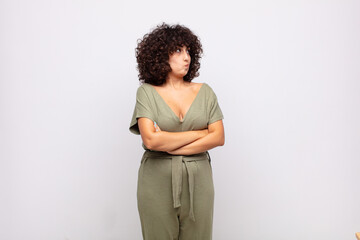  shrugging, feeling confused and uncertain, doubting with arms crossed and puzzled look