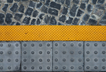 Warning bumps for blind people at the sidewalk