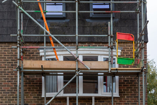 Scaffolding poles erected on the from of a house to enable construction or maintenance work to be carried out