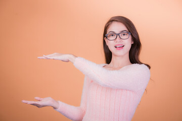 Portrait of beautiful asia young woman, on yellow color background with copy space. Human face...