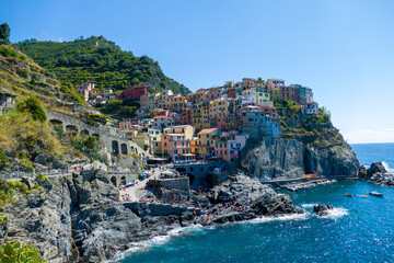 Fototapeta na wymiar Village of Manarola, Cinque Terre coast of Italy. magnificent seen from the Italian coast, Manarola is a small town in Liguria, in the north of Italy - aerial view with a drone - travel concept