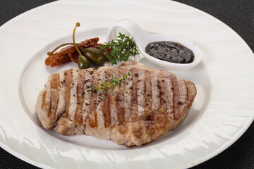 Grilled pork steak with pepper sauce