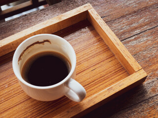 Black coffee with white cup on old wooden table, black morning coffee
