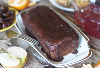 Food background.Homemade baking chocolate pumpkin muffin, iced on a wooden table with food.