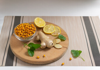 Ingredients for sea buckthorn tea. Sea buckthorn, lemon, ginger and lemon balm. Autumn beverage....