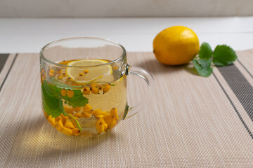 A cup of tea with and Ingredients on a brown background. Warming autumn beverage. Selective focus....