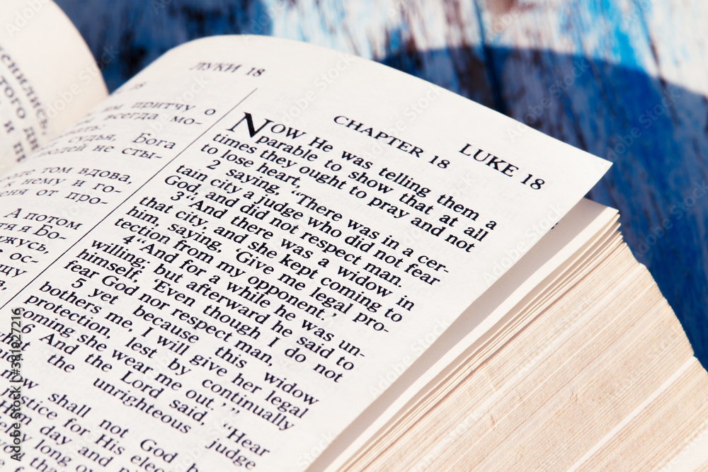 Fototapete on an old paint table is an open bible. you can only see part of the book with text in english. the 