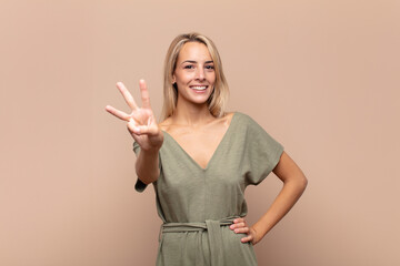  smiling and looking friendly, showing number three or third with hand forward, counting down