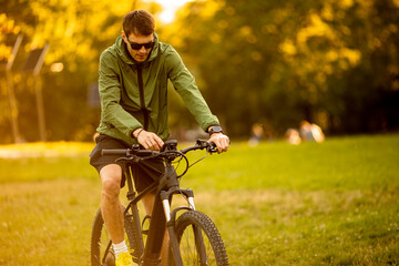 Young man riding ebike in the park