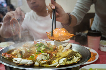 chinese people eat steamed crab by chopsticks