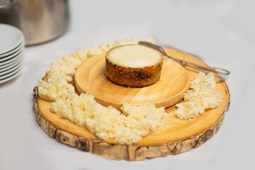 cheese on wooden sliced cheese board