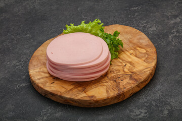 Sliced pork natural sausages over board