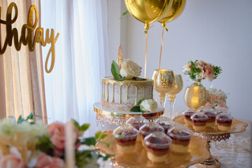 Tasty birthday cake, decorated with flowers and balloons