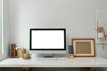 Stylish minimalistic white table workplace with supplies, coffee cup and house plant. For product display montage.