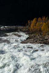 Rapid River Flow Over Rocky Landscape