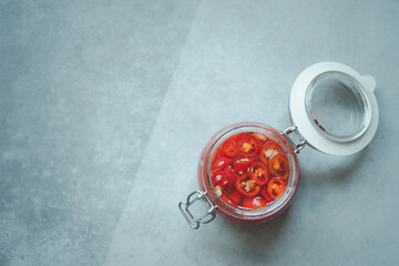 Close up vinegar with floating chili above.
