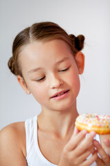 cute girl holding an appetizing glazed donut in her hands