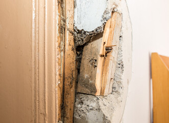 Old wall in the house needs renovation. Man repairing the flat. Do it yourself maintenance works.