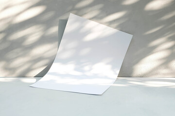 Blank with paper with light and shadow on gray background.