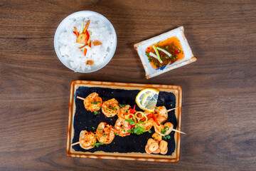 Tasty grilled shrimps with spices and rice served on a plate
