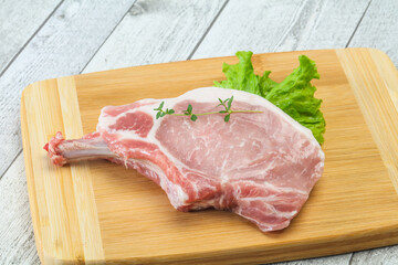 Raw pork bone steak over wooden