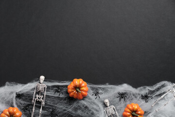 Dark halloween background with pumpkins, skeletons, spiders, web. Halloween party invitation card...