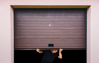 man with hands holds pvc garage door
