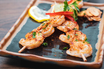 Tasty grilled shrimps with spices served on a plate