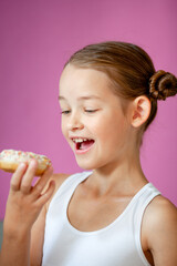 cute girl holding an appetizing glazed donut in her hands