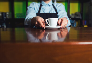 Barman serving cup of coffee