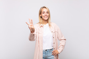  smiling and looking friendly, showing number three or third with hand forward, counting down