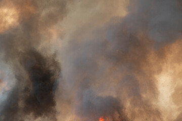 Fototapeta na wymiar raging dust smoke pattern background of fire burn in grass fields, forests and black