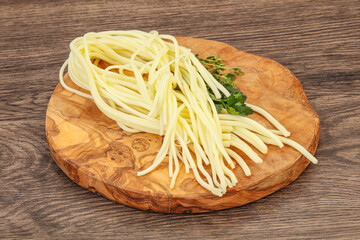 Chechil spaghetti cheese over board