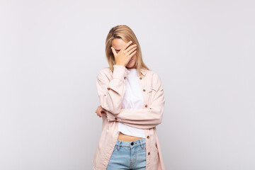  looking stressed, ashamed or upset, with a headache, covering face with hand