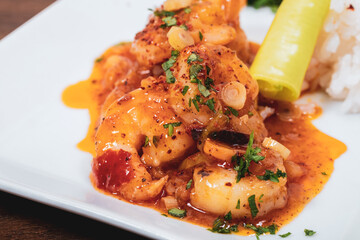 Tasty grilled shrimps with spices and rice served on a plate