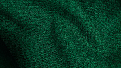 Crumpled dark green fabric texture, wavy wrinkled cloth pattern. soft green linen fabric background.