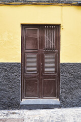 Colored Yellow Facade With Wooden Door