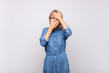  covering face with both hands saying no to the camera! refusing pictures or forbidding photos